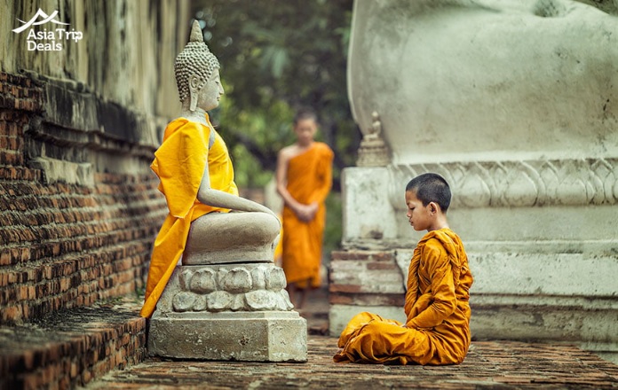 Novices-monk-vipassana-meditation-at-front-of-Buddha-statue.jpg