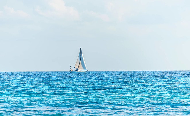 pngtree-a-sailboat-gliding-across-the-open-sea-embarking-on-a-peaceful-cruise-photo-photo-image_30447040.jpg